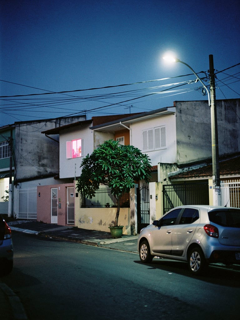 Sloping residential street in Cidade São Jorge, Santo André, at blue hour